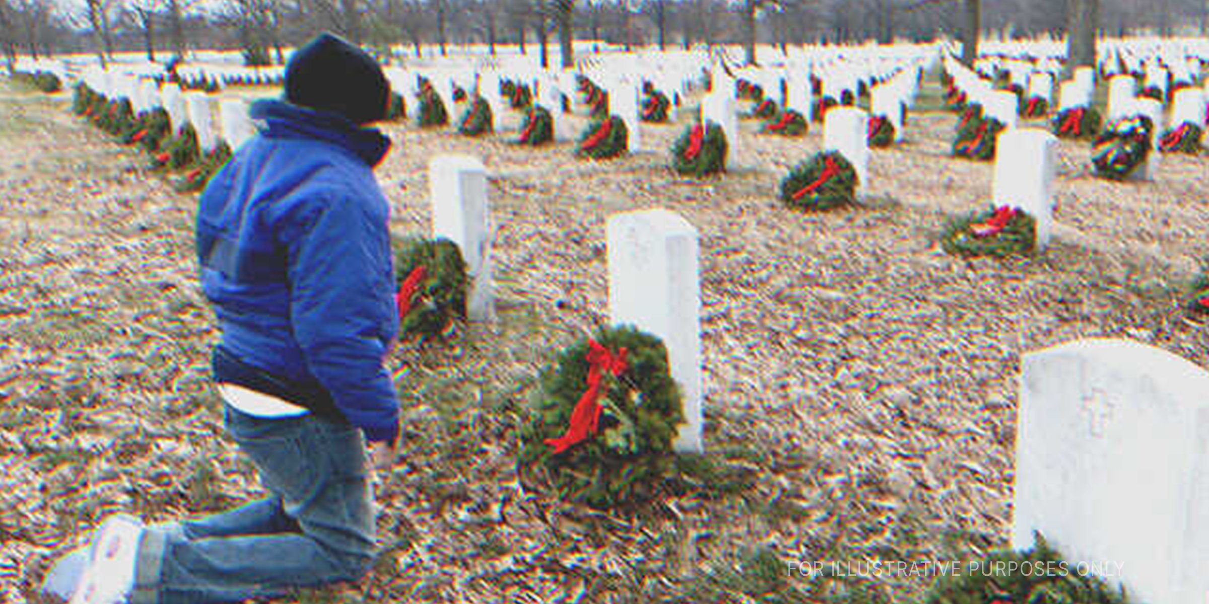Man sitting near a grave. | Source: Getty Images