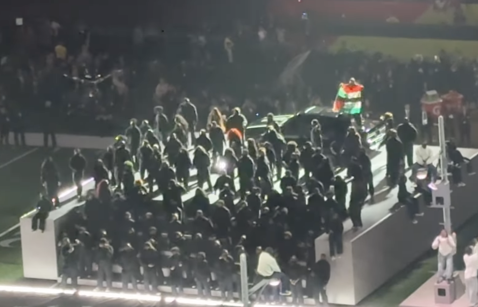 A member of the 400-member field cast is seen raising a flag in the middle of Kendrick Lamar's performance, dated February 10, 2025 | Source: Instagram/ jessekirschnbc
