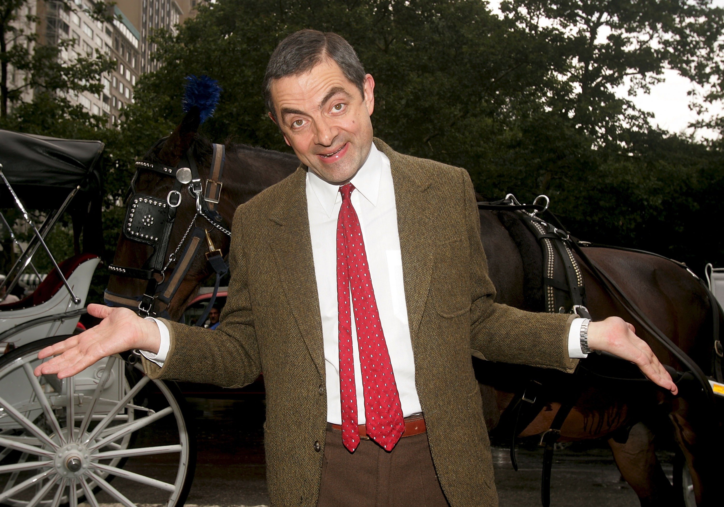 Rowan Atkinson dressed up as his iconic character Mr. Bean and posed in front of a horse and buggy on July 19, 2007, in New York City to promote his new film "Mr. Beans' Holiday." | Source: Getty Images