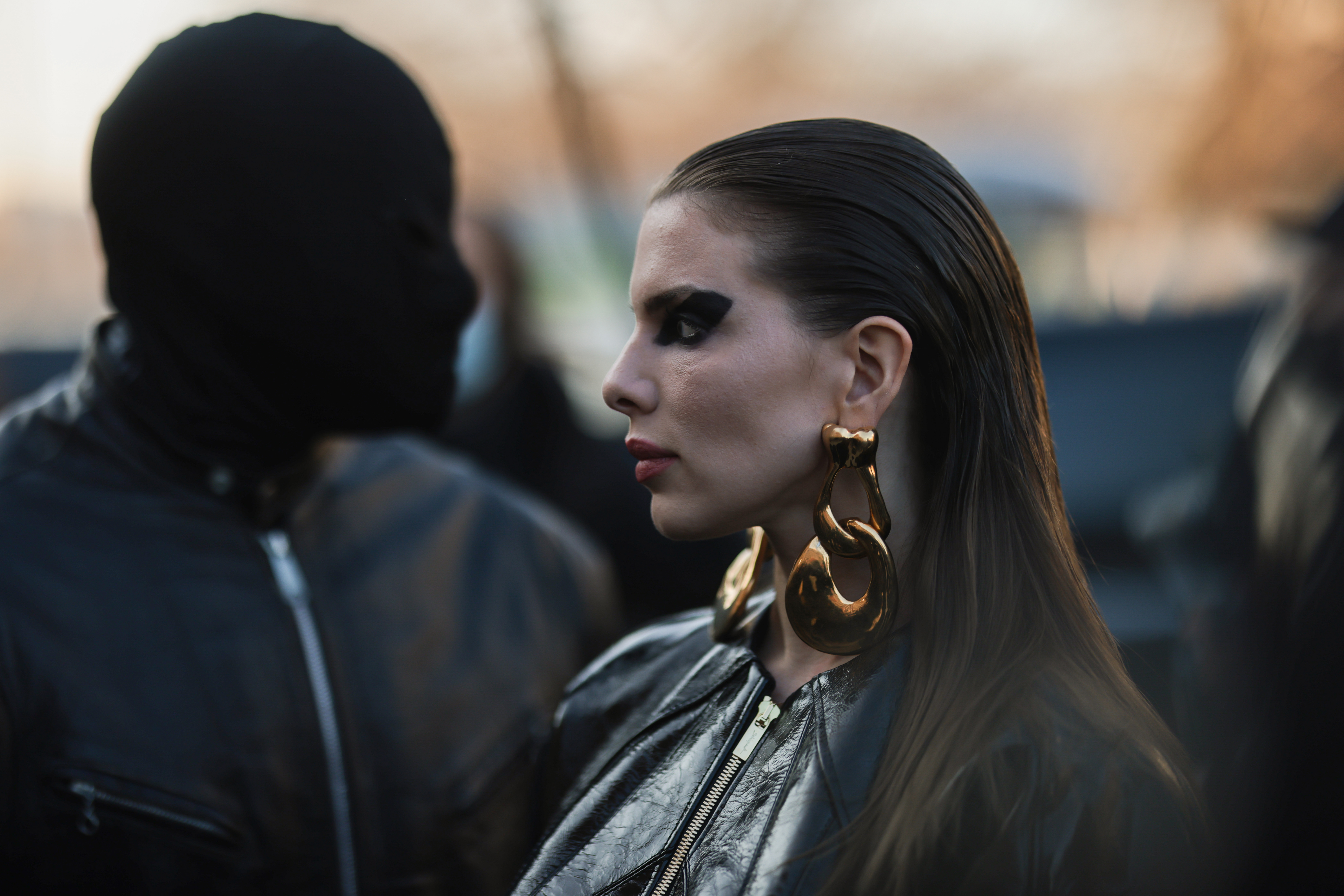Julia Fox looking on as Kanye West stands behind her during the 2022 Paris Fashion Week. | Source: Getty Images