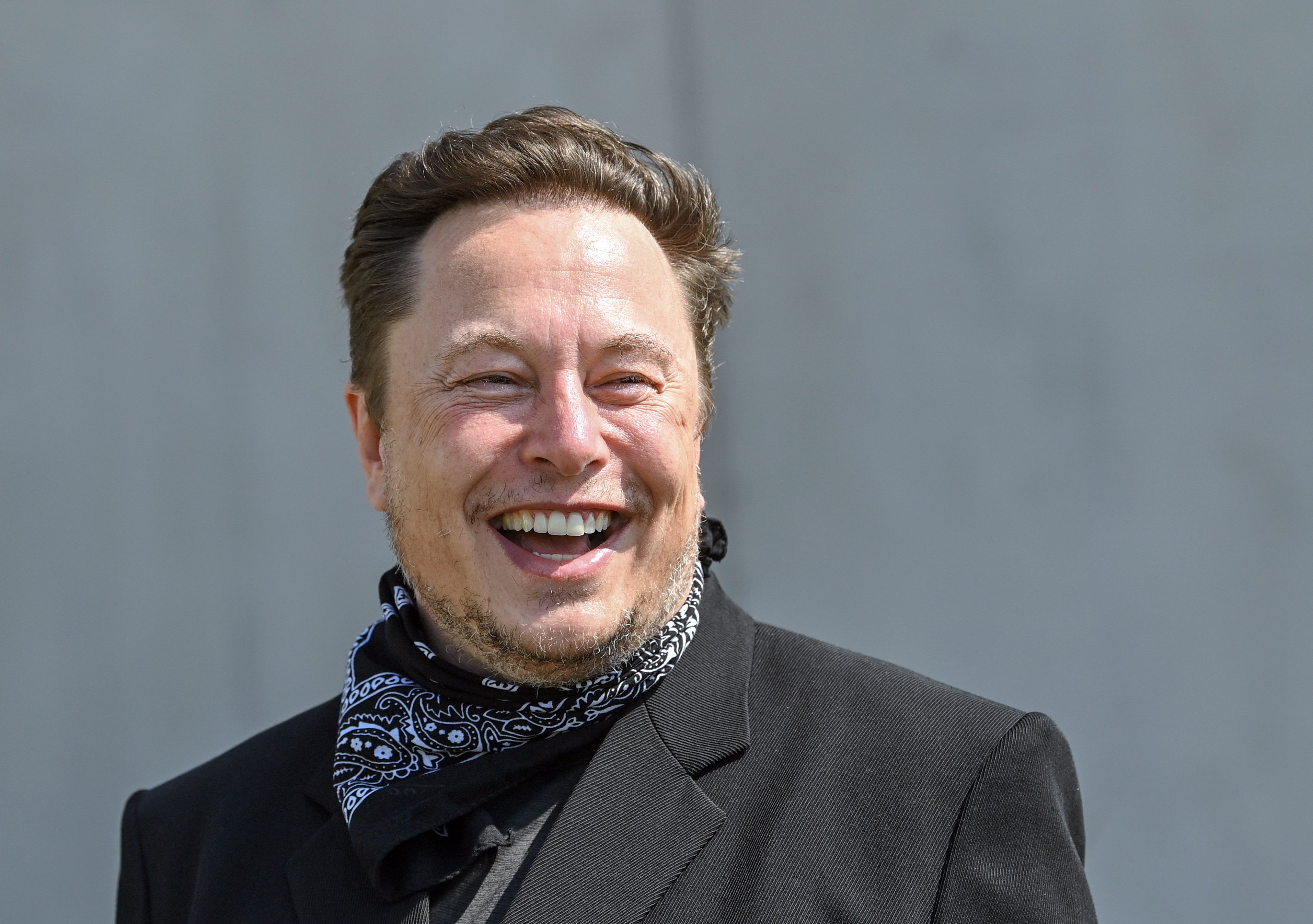 Elon Musk, Tesla CEO, stands at a press event on the grounds of the Tesla Gigafactory. | Source: Getty Images
