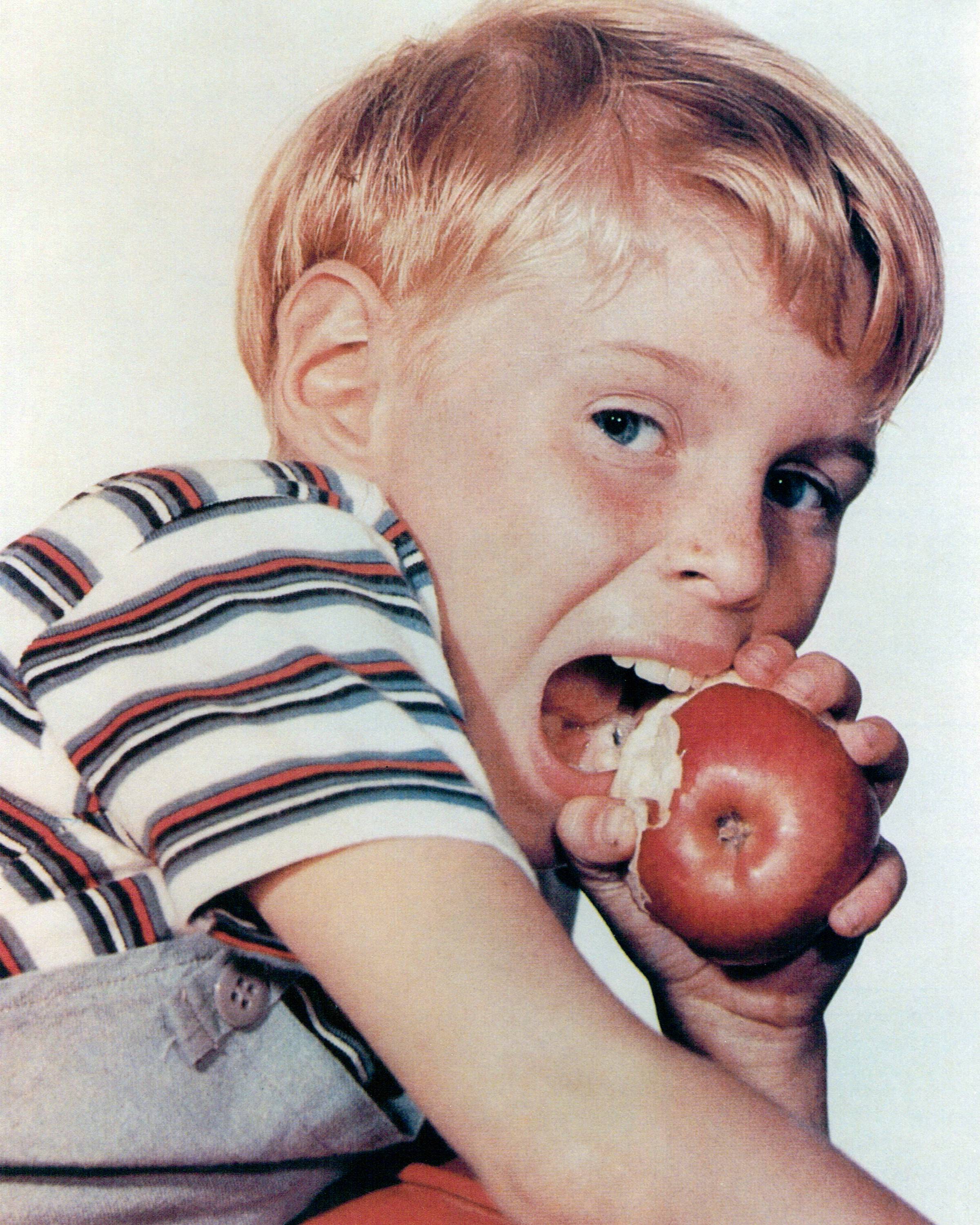 Jay North biting into an apple in a portrait issued as publicity for the U.S. television series, "Dennis the Menace," circa 1960 | Source: Getty Images