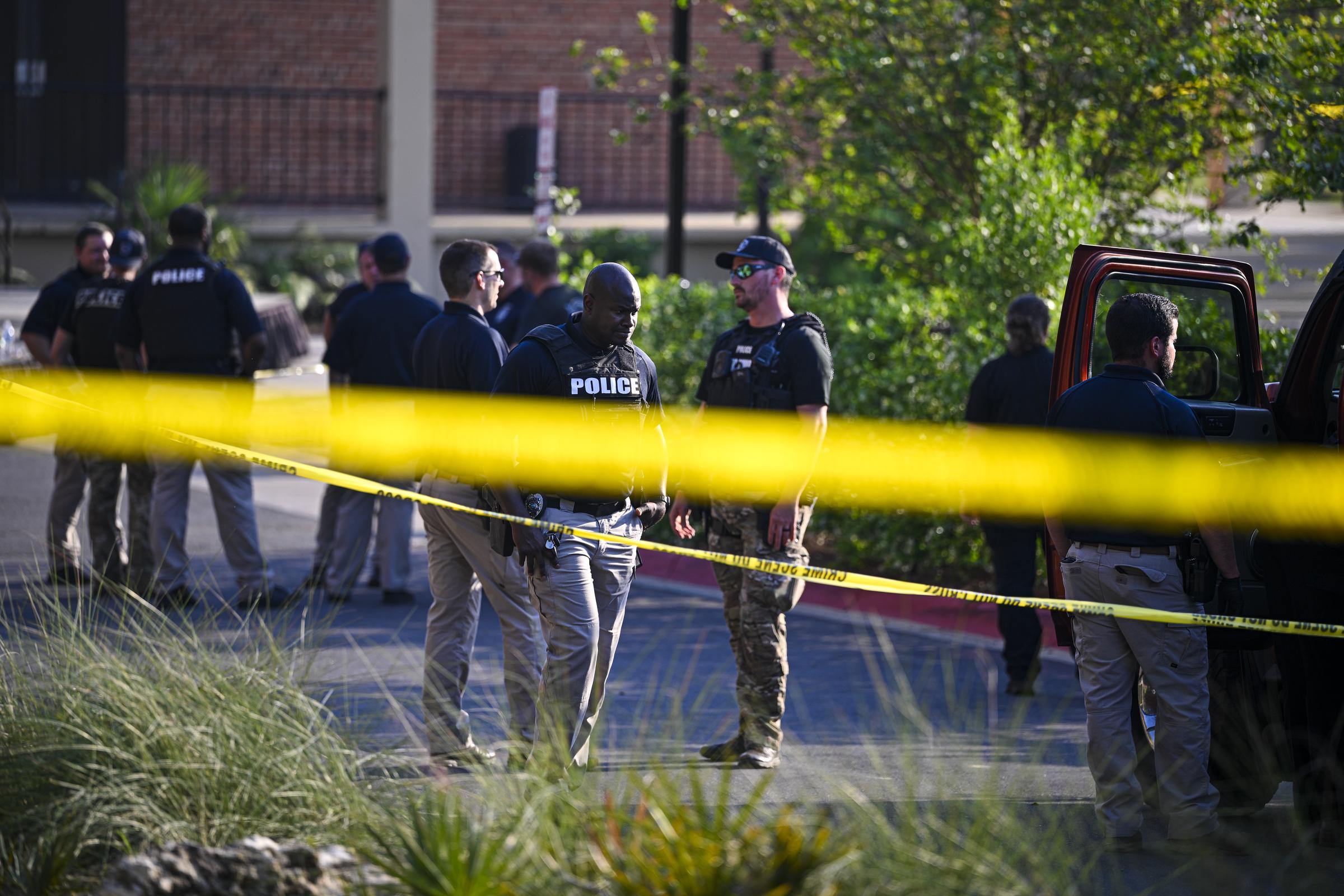 Police gather behind caution tape as the investigation unfolds on FSU's main campus after a deadly shooting | Source: Getty Images