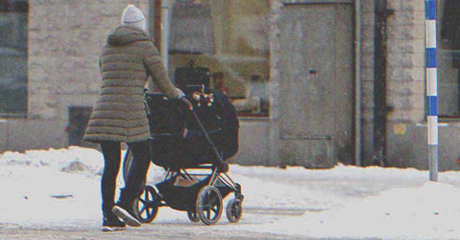 A woman pushing a stroller on the street | Source: Shutterstock