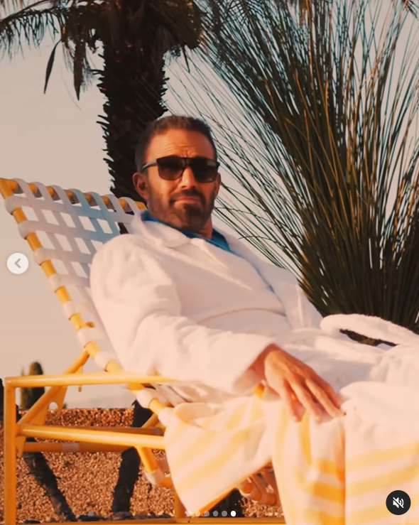 Ben Affleck dressed in a white robe at a swimming pool | Source: Instagram/gq