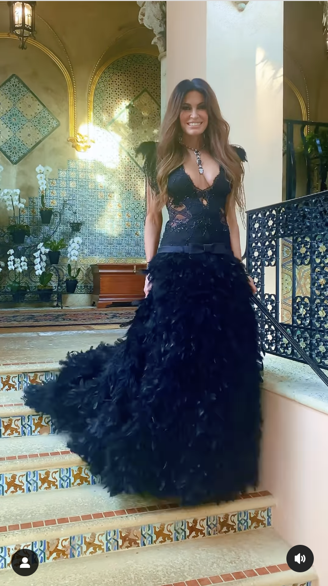Kimberly Guilfoyle is seen descending the staircase in a black dress at the Wags to Riches Gala, in a video shared on March 24, 2025 | Source: Instagram/realoscarlopez