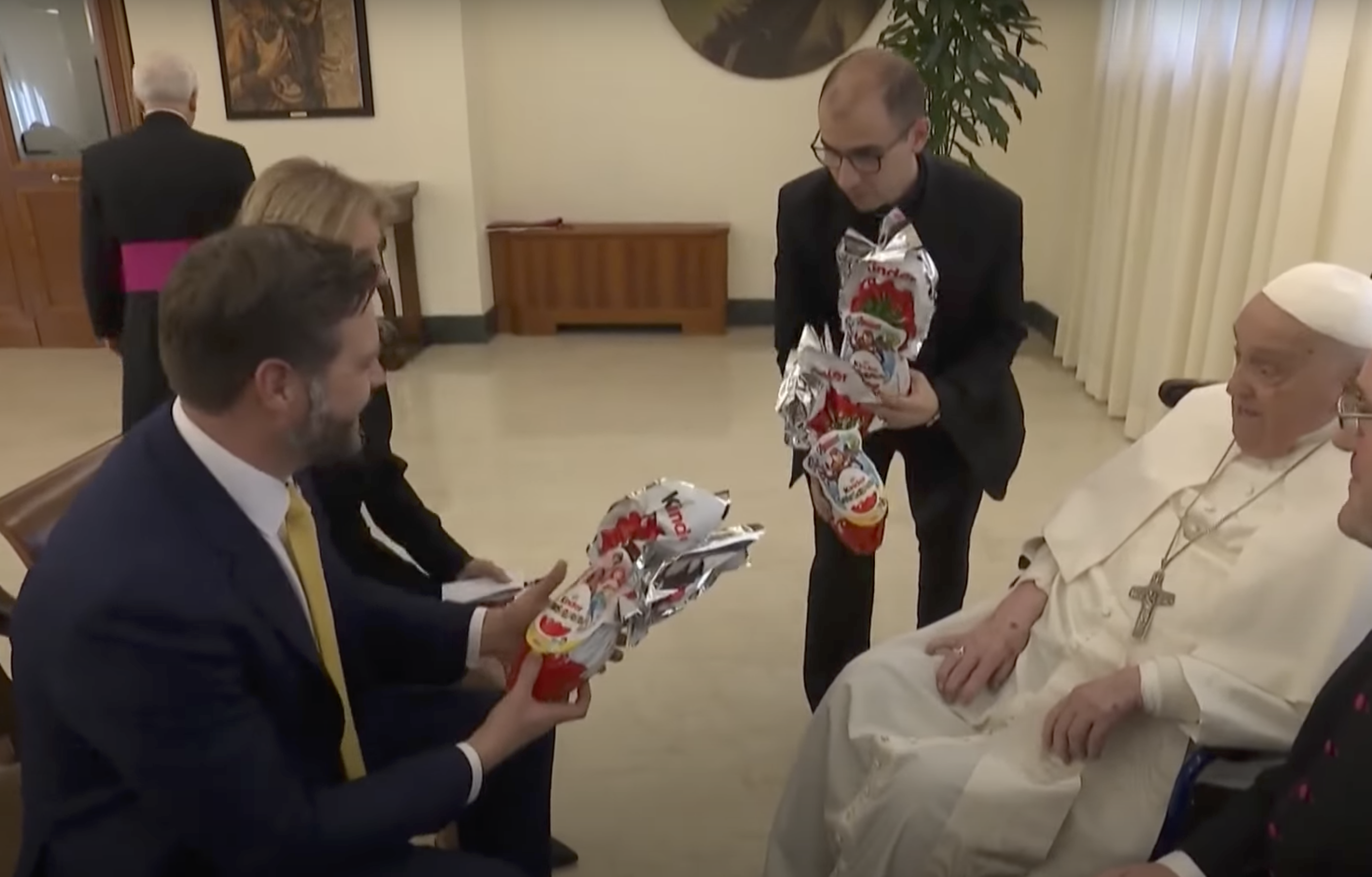 A screenshot of a priest gifting JD Vance on Pope Francis' behalf from a video dated April 20, 2025. | Source: YouTube/AFP News Agency