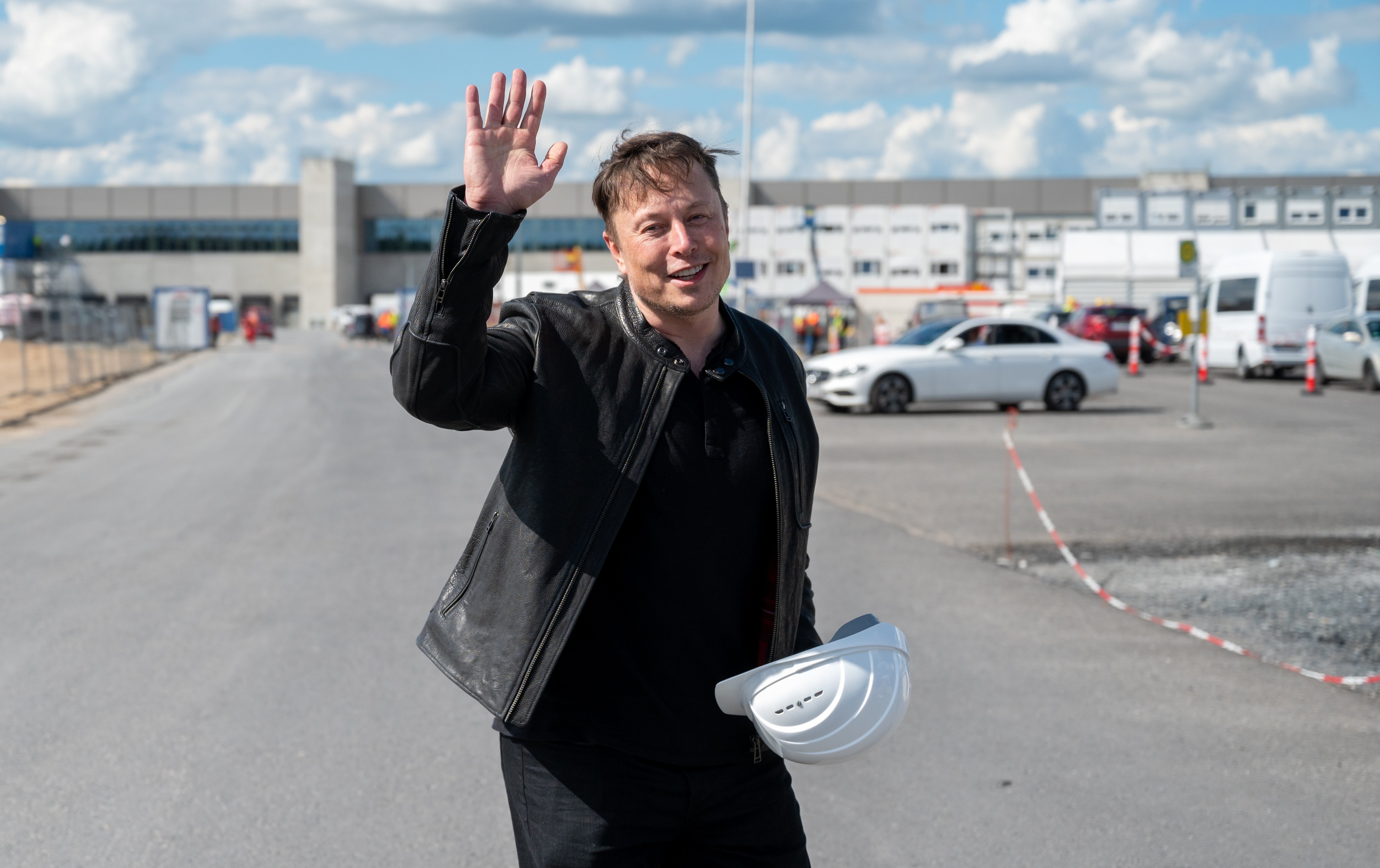 Elon Musk, Tesla CEO, stands on the construction site of the Tesla factory and waves. | Source: Getty Images