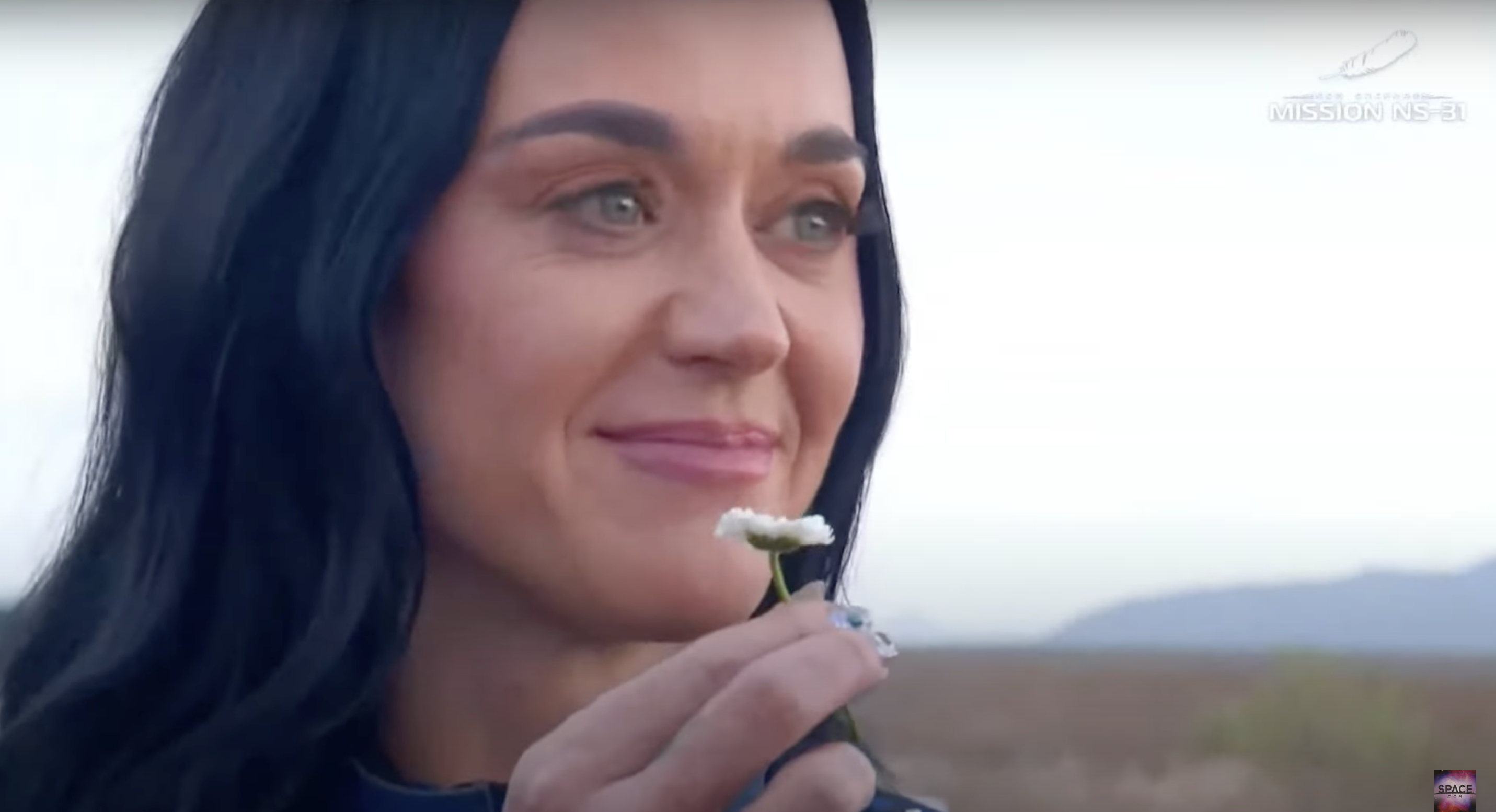 Katy Perry holds a daisy flower while sharing her thoughts after her first space mission, as seen in a video dated April 14, 2025 | Source: YouTube/VideoFromSpace