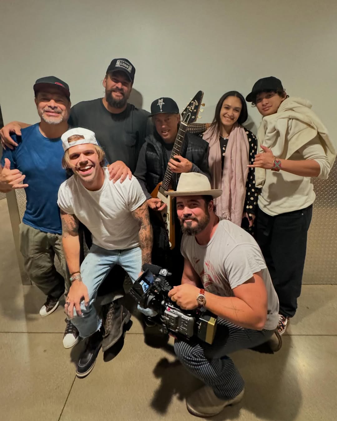 Jason Momoa, Lola, and Nakoa-Wolf posing with others during the Metallica concert, from a post dated December 14, 2024 | Source: Instagram/prideofgypsies