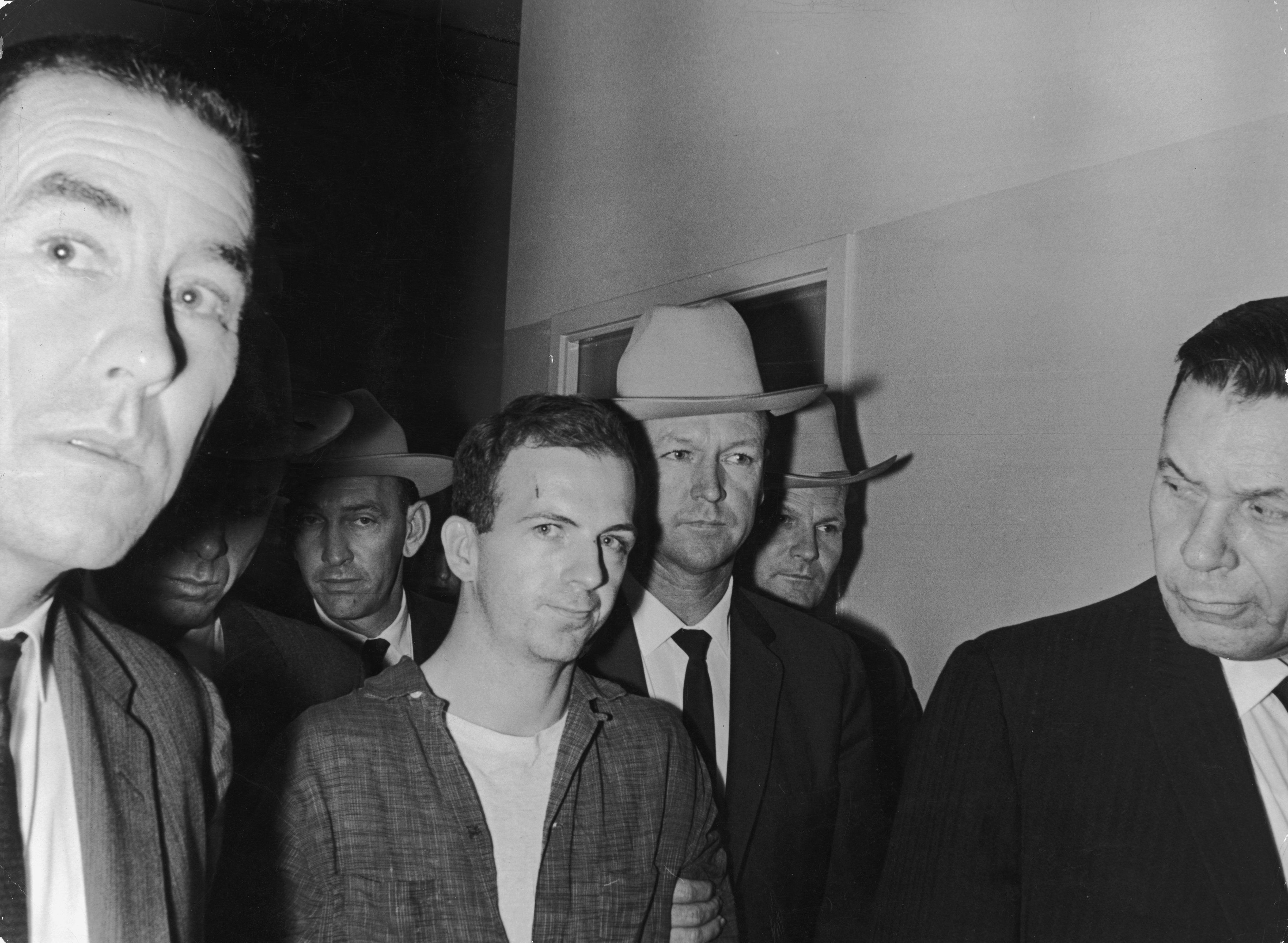 Lee Harvey Oswald being taken into custody by police after allegedly shooting former president John F. Kennedy on November 22, 1963, in Dallas, Texas. | Source: Getty Images