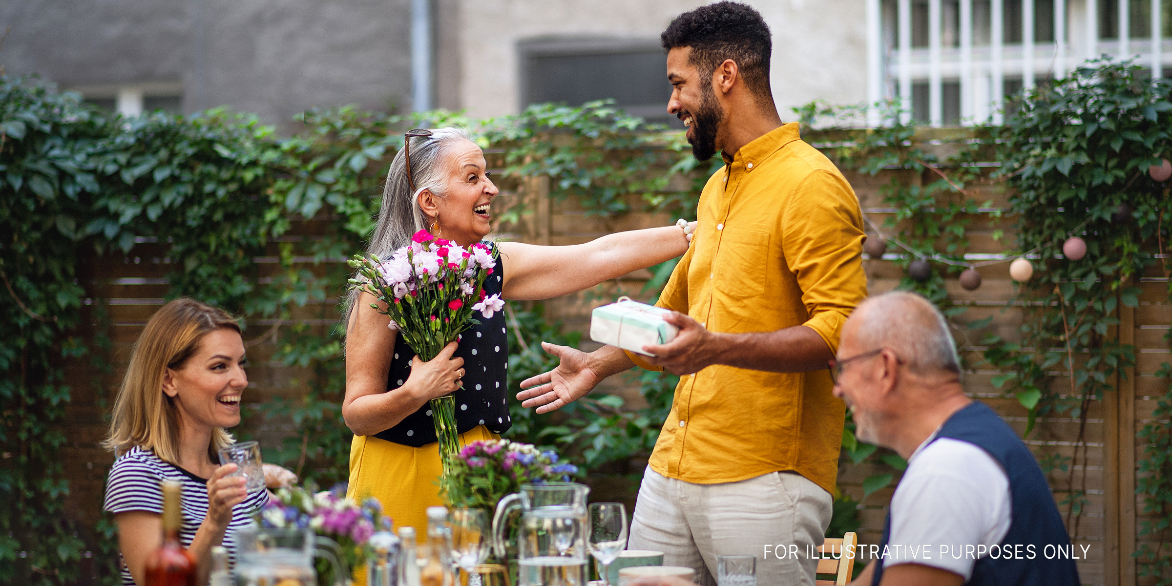 A person of color hugging an elderly woman | Source: Shutterstock